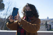 Someone using their iPhone 12 in Rome, Italy, to take a selfie