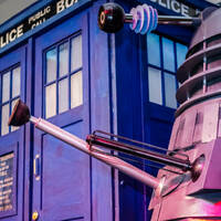 Daleks standing next a Dr Who Police Box 