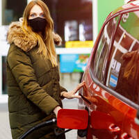 Someone refilling their car with gas