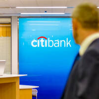 Someone walking by a Citibank branch