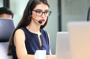 Someone working in an IT support desk role with telephone headset