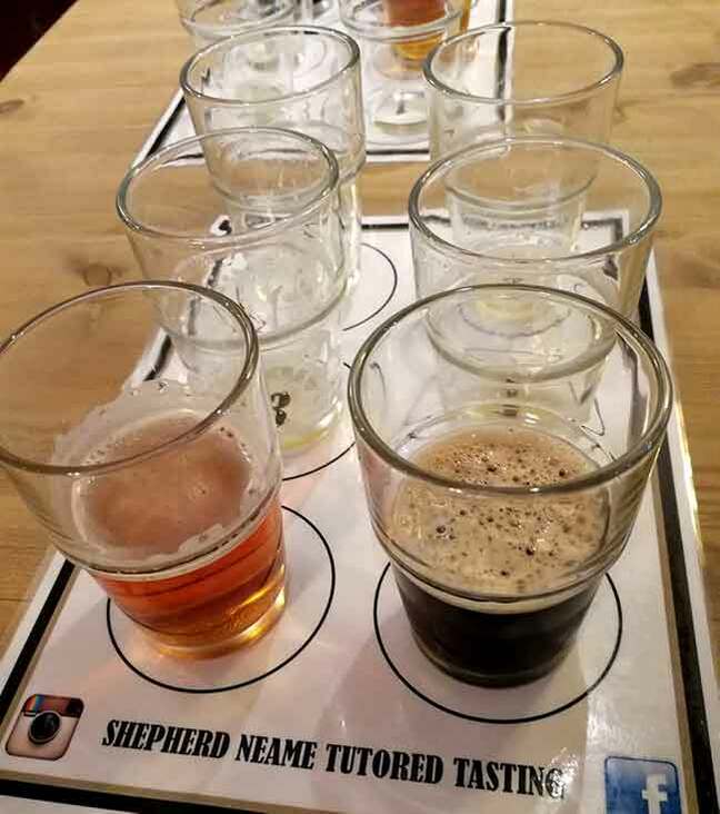 Photo of half-drunk glasses on a table during a beer tasting at the Shepherd Neame Brewery