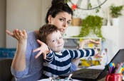 A mother trying to work from home with a small child