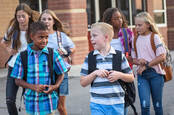 Kid tries to impress his friend as they walk to school