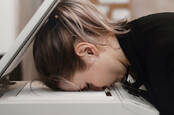 Someone face down on a printer-scanner in frustration