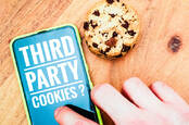 A phone showing 'third party cookies?' on screen next to a cookie