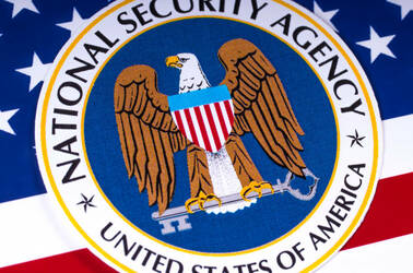 The NSA logo over a US flag