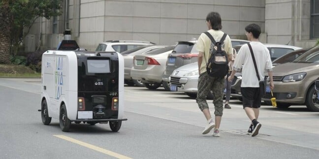 An Alibaba parcel delivery robot in action delivering packages on a university campus in Wuhan, China. 