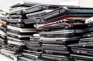 A few piles of broken laptops
