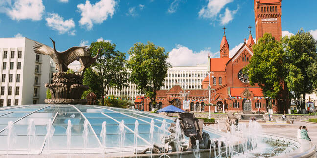 Church Of Saints Simon And Helen or Red Church And Fountain At Independence Square In Minsk, Belarus