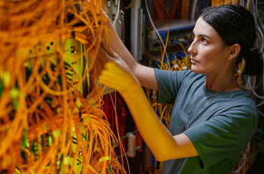 A technician trying to sort through data center cables