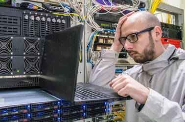 Someone despairing at their servers not working in a datacenter