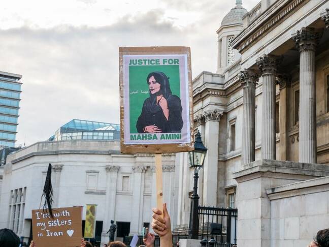 A young woman holds up a sign placard in London's Trafalgar Sq on sept 24 at a protest over the death in Iranian police custody of Mahsa Amini