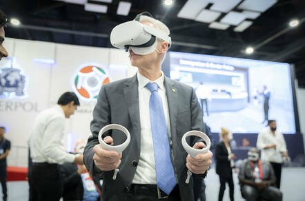 INTERPOL Secretary General Jürgen Stock wearing a VR headset at a session in India about the org's Metaverse