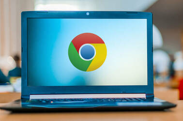 The Google Chrome logo displayed on a laptop on a desk