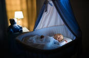 A baby sleeping in a crib