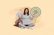 Someone with a laptop holding up money