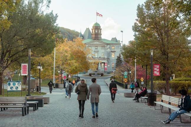 Photo of McGill University front pathway with lots of students on sunny fall autumn day