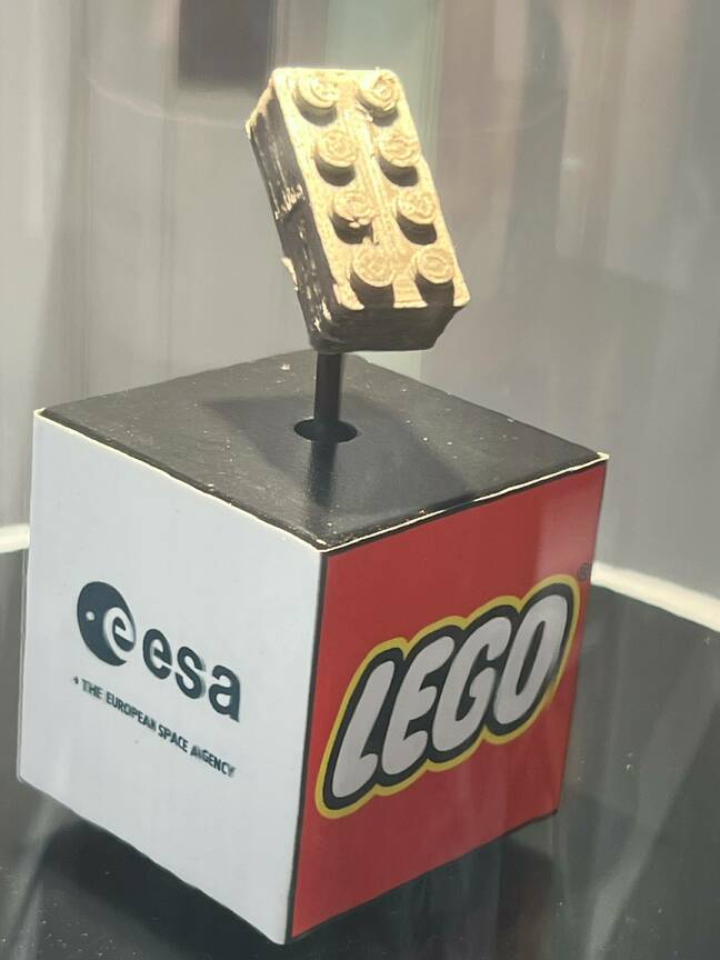 Lego space brick mounted on a display stand showing the ESA and Lego logos