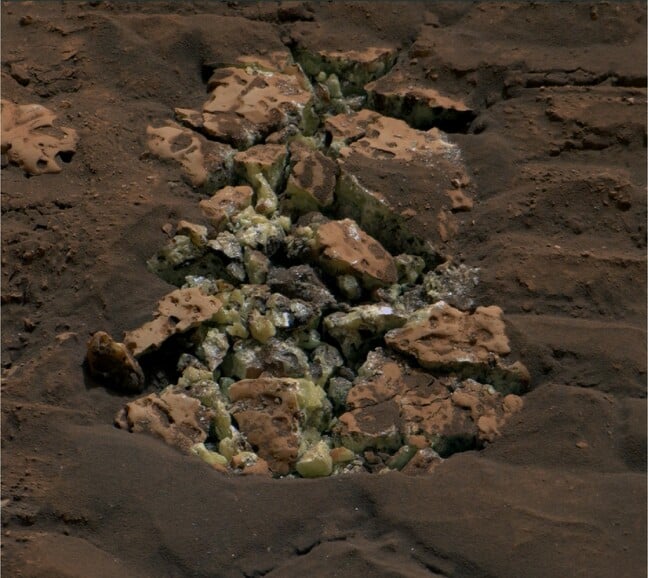 These yellow crystals were revealed after NASA’s Curiosity happened to drive over a rock and crack it open on May 30. Using an instrument on the rover’s arm, scientists later determined these crystals are elemental sulfur Credit: NASA/JPL-Caltech/MSSS