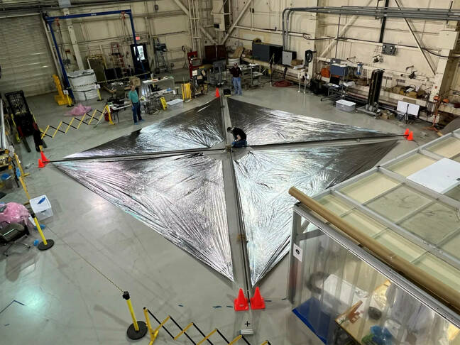 Engineers at NASA's Langley Research Center test deployment of the Advanced Composite Solar Sail System's solar sail. The unfurled solar sail is approximately 30 feet (about 9 meters) on a side. Since solar radiation pressure is small, the solar sail must be large to efficiently generate thrust