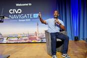 Kelsey Hightower seated on stage during a fireside chat at Civo's Navigate event in Berlin