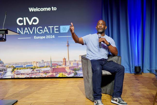 Kelsey Hightower seated on stage during a fireside chat at Civo's Navigate event in Berlin