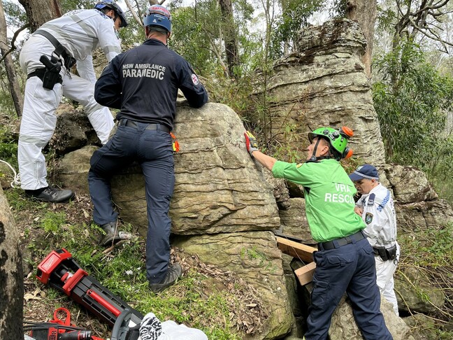 Rescue workers attempting to free woman who lost her phone. Image: NSW Ambulance