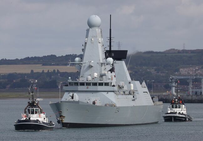 The harbour tugs BOUNTIFUL and INDULGENT manoeuvre the Royal Navy warship HMS DIAMOND towards the harbour mouth as the destroyer leaves the Naval Base Editorial credit: Kevin Shipp/ Shutterstock