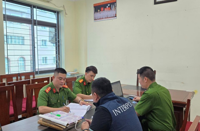 Interpol and domestic police officers examine documents related to Operation Secure's investigations into infostealer malware in Asia