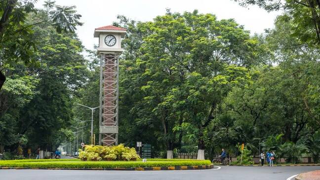 IIT Kharagpur - 01 Aug 2022 - The Alumni Clock Tower at IIT Kharagpur campus. Students cycle past the Alumni Clock Tower on route to lectures at IIT Kharagpur campus . mrinalpal / Shutterstock.com