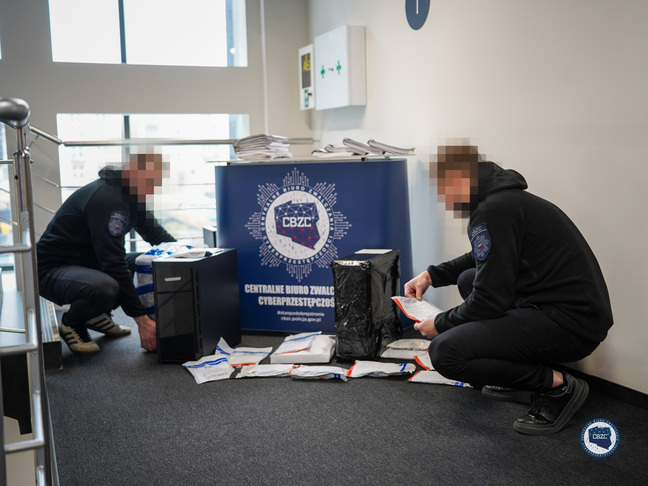 CBZC officers pose with seized evidence taken from alleged DDoS gang members' residences